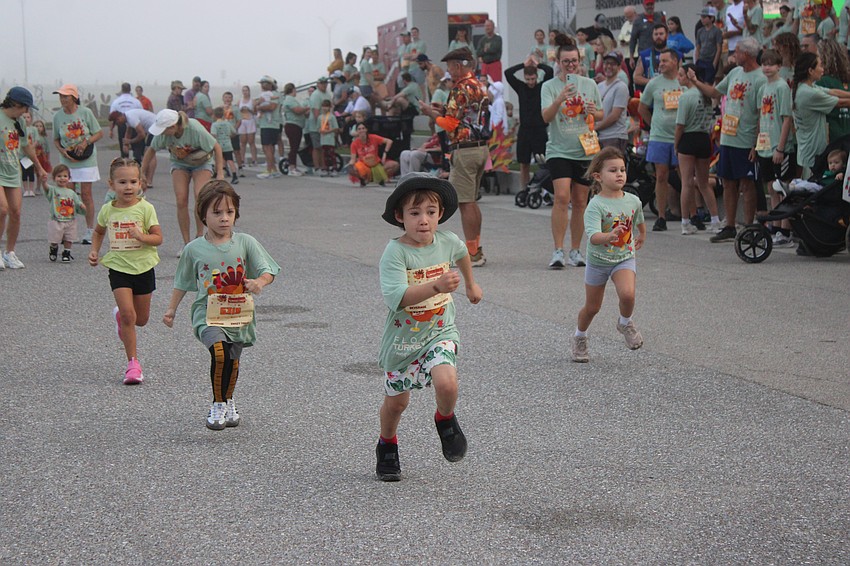 Mill Valley, California's Max Walsh, 4, leads the pack in one of the kids races at the Florida Turkey Trot on Thanksgiving.
