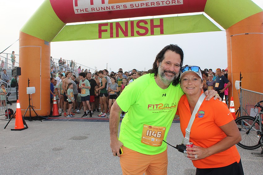 Fit2Run CEO Parks Robinson takes a photo with Nathan Benderson Park Director of Events Sarah Hartz before the 2025 Florida Turkey Trot which benefits the Nathan Benderson Park Conservancy and the Big Bill Foundation, which honors Parks' late dad, Bill Robinson.