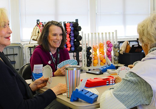 American Contract Bridge League-certified bridge player Patty Mayer checks out her hand while playing a round at the club's new meeting spot at the Bayfront Park Recreation Center.