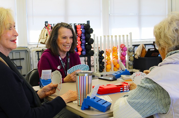 American Contract Bridge League-certified bridge player Patty Mayer checks out her hand while playing a round at the club's new meeting spot at the Bayfront Park Recreation Center.