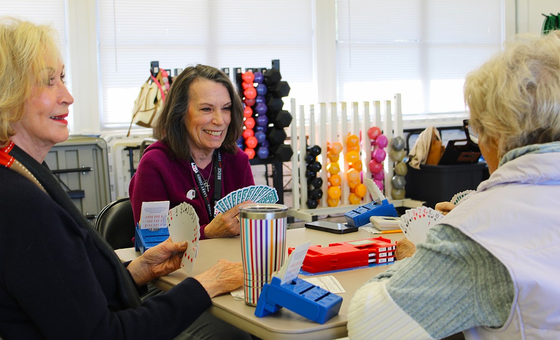 American Contract Bridge League-certified bridge player Patty Mayer checks out her hand while playing a round at the club's new meeting spot at the Bayfront Park Recreation Center.