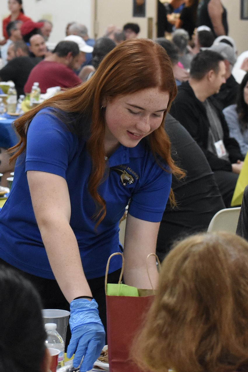 Cardinal Mooney High School senior Elle VanderPol serves a plate.