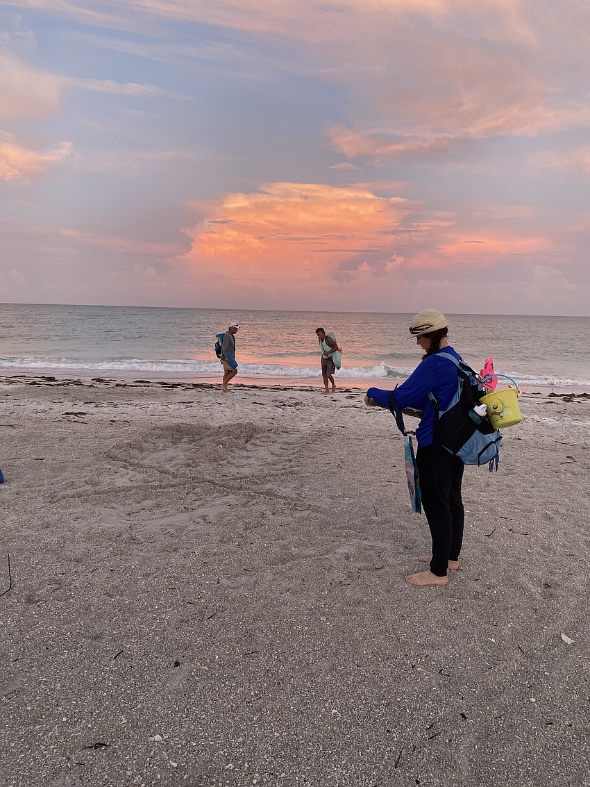 Longboat Key Turtle Watch volunteers Tim Thurman, Leo Kissling and Laurie Schmitt log a newly-dug sea turtle nest on an early June morning.