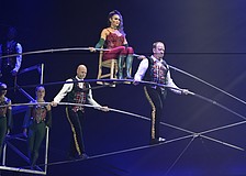 Lijana Wallenda perches on a chair balanced on a shoulder bar carried by her brother Nik Wallenda and Paul Matthew Lopez in the "Wonderland: Believe" circus, which runs through Jan. 4 in a big top near the UTC Mall.