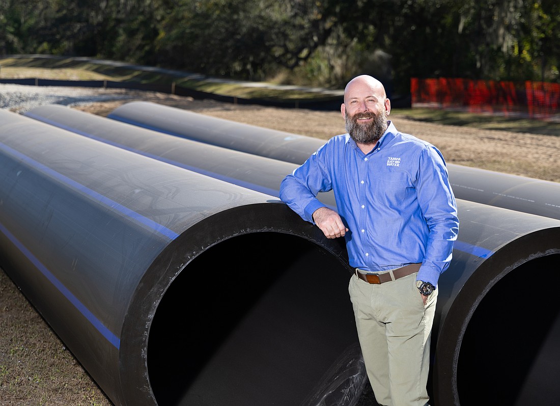 Brandon Moore, spokesperson for Tampa Bay Water, poses near portions of the new South Hillsborough Pipeline.