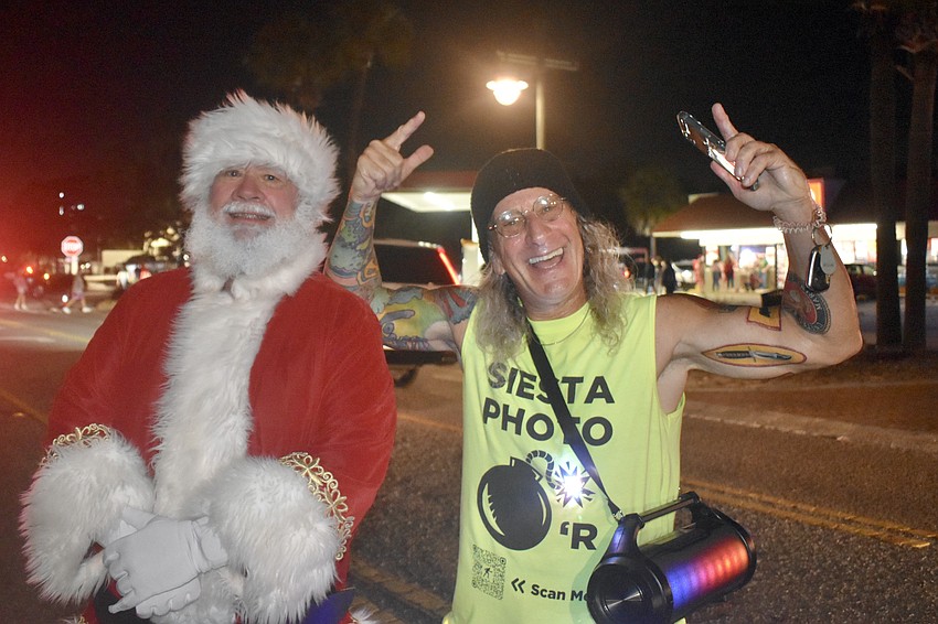 Santa Claus poses with Siesta Photobomber Larry Frankel.