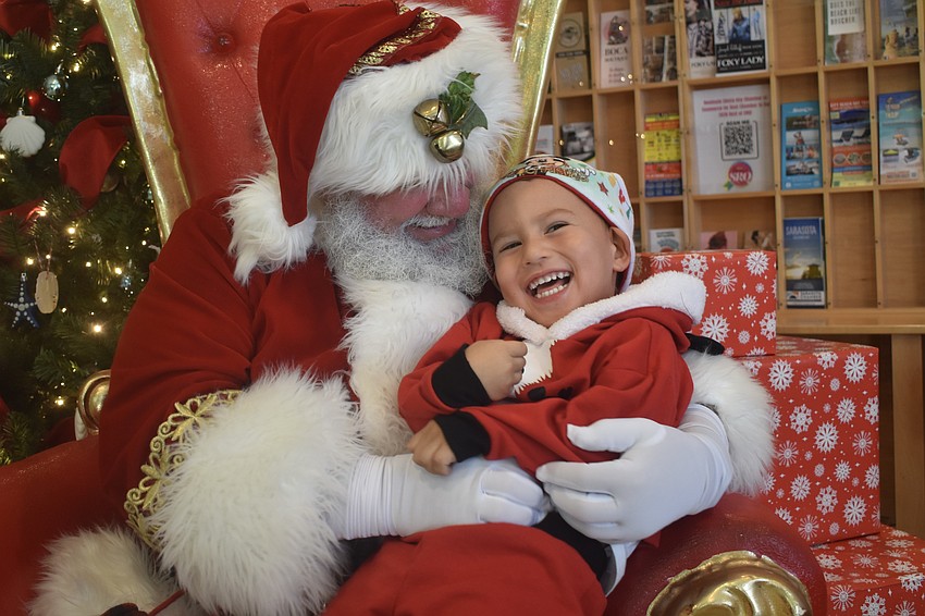 Santa Claus sits with Giacomo Echeverria, 3.