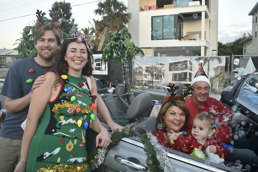 Mick Woolerton, his fiancée Bailey Seiner, her parents Becky and Henry Seiner, and their grandson Archie Seiner, 1, were together for the parade, while the car's new bubble machine entertained Archie Seiner.