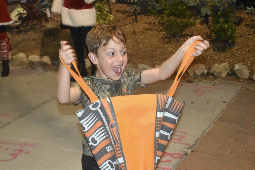 Otto Vallee, 8, welcomes parade participants with candy.