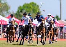 Mica Sarraco (white) battles with Olivia Uchiritz (blue) during a polo match at Sarasota Polo Club.