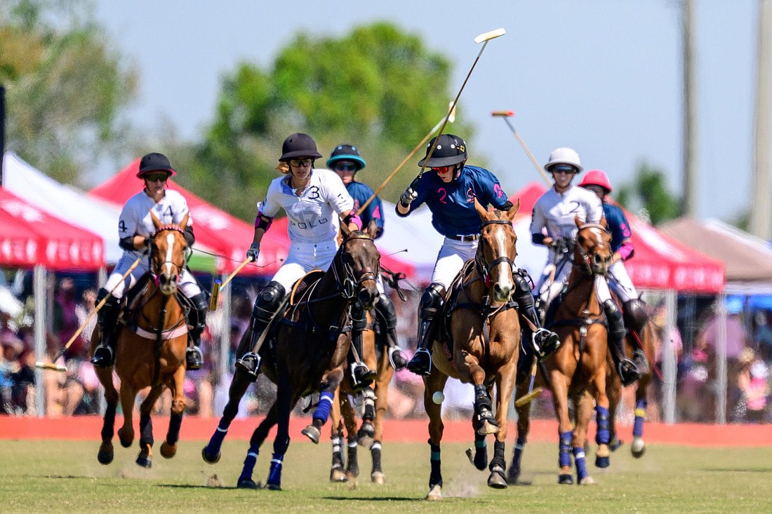 Mica Sarraco (white) battles with Olivia Uchiritz (blue) during a polo match at Sarasota Polo Club.