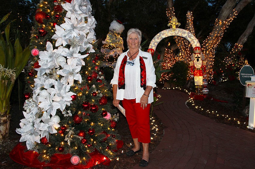 Iris White, Longboat Island Chapel board of trustees president, stands by the tree she decorated for Christmas in the Garden.