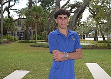 Samuel Shamsey poses for a photo on Dec. 1 outside the entrance to Cardinal Mooney Catholic High School. The striker leads a senior-heavy pack of Cougars for the 2025-26 season.