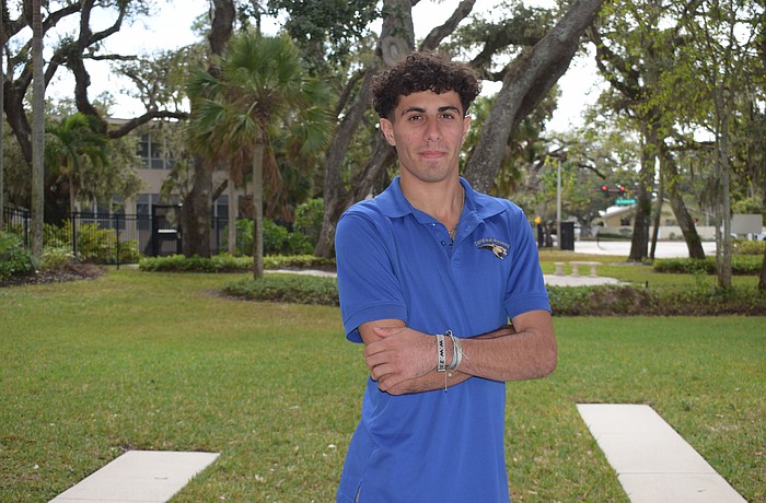 Samuel Shamsey poses for a photo on Dec. 1 outside the entrance to Cardinal Mooney Catholic High School. The striker leads a senior-heavy pack of Cougars for the 2025-26 season.