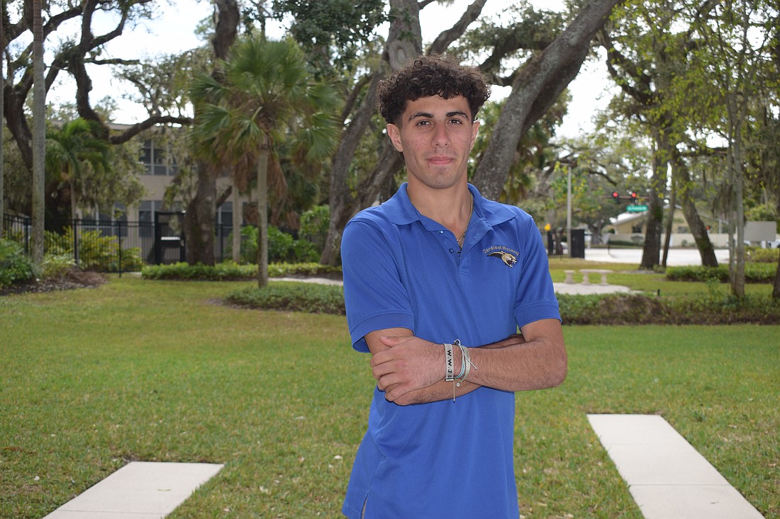 Samuel Shamsey poses for a photo on Dec. 1 outside the entrance to Cardinal Mooney Catholic High School. The striker leads a senior-heavy pack of Cougars for the 2025-26 season.