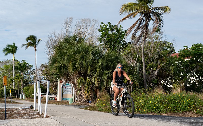 An e-biker rides south on the sidewalk parallel to Gulf of Mexico Drive. The town of Longboat Key is having initial discussions about writing a new ordinance to regulate the use of e-bikes to increase public safety.