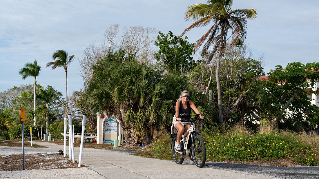 An e-biker rides south on the sidewalk parallel to Gulf of Mexico Drive. The town of Longboat Key is having initial discussions about writing a new ordinance to regulate the use of e-bikes to increase public safety.