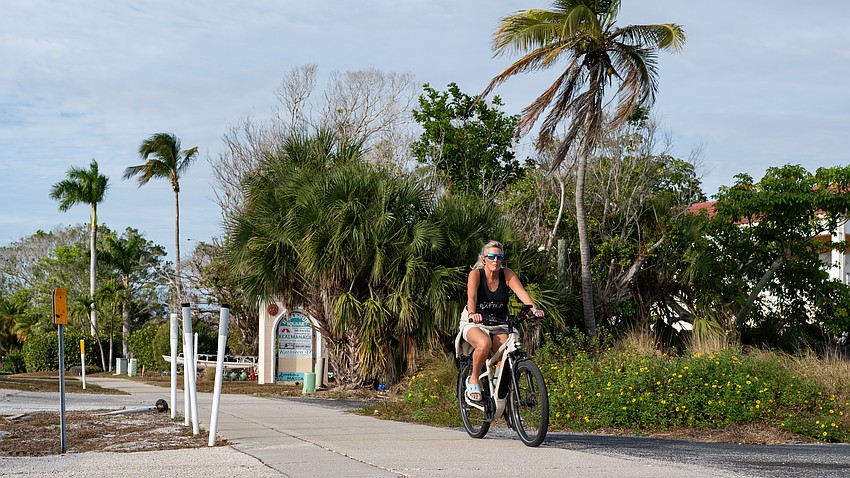 An e-biker rides south on the sidewalk parallel to Gulf of Mexico Drive. The town of Longboat Key is having initial discussions about writing a new ordinance to regulate the use of e-bikes to increase public safety.