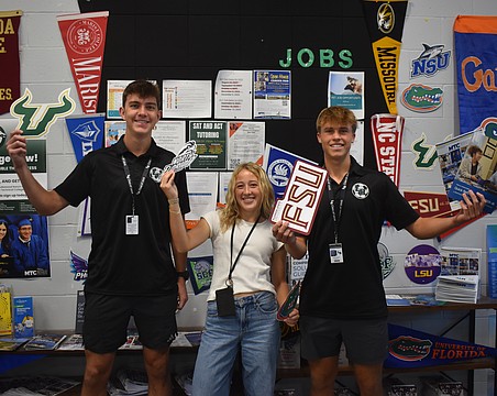 Seniors Gavin Moore, Abigail Frint and Ryan Johnson were among 12 students at Lakewood Ranch High School to set up and spread the word about the opportunities available at the new College and Career Center.