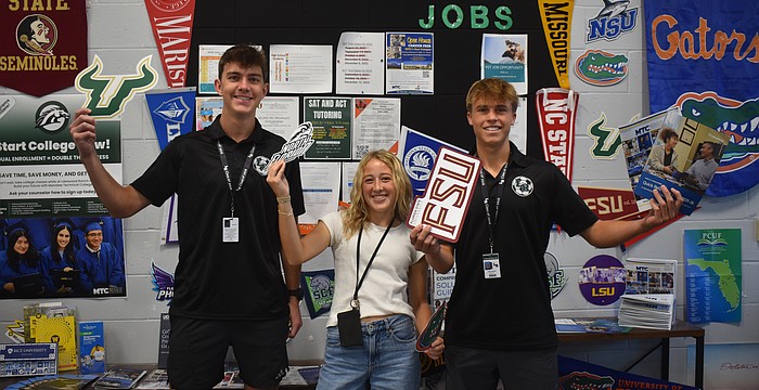 Seniors Gavin Moore, Abigail Frint and Ryan Johnson were among 12 students at Lakewood Ranch High School to set up and spread the word about the opportunities available at the new College and Career Center.