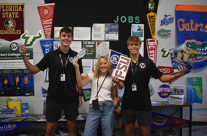 Seniors Gavin Moore, Abigail Frint and Ryan Johnson were among 12 students at Lakewood Ranch High School to set up and spread the word about the opportunities available at the new College and Career Center.