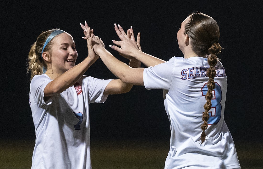 Seabreeze striker Olivia Chase (left) celebrates a goal in a Dec. 16, 2024 game against Spruce Creek. File photo by Michele Meyers