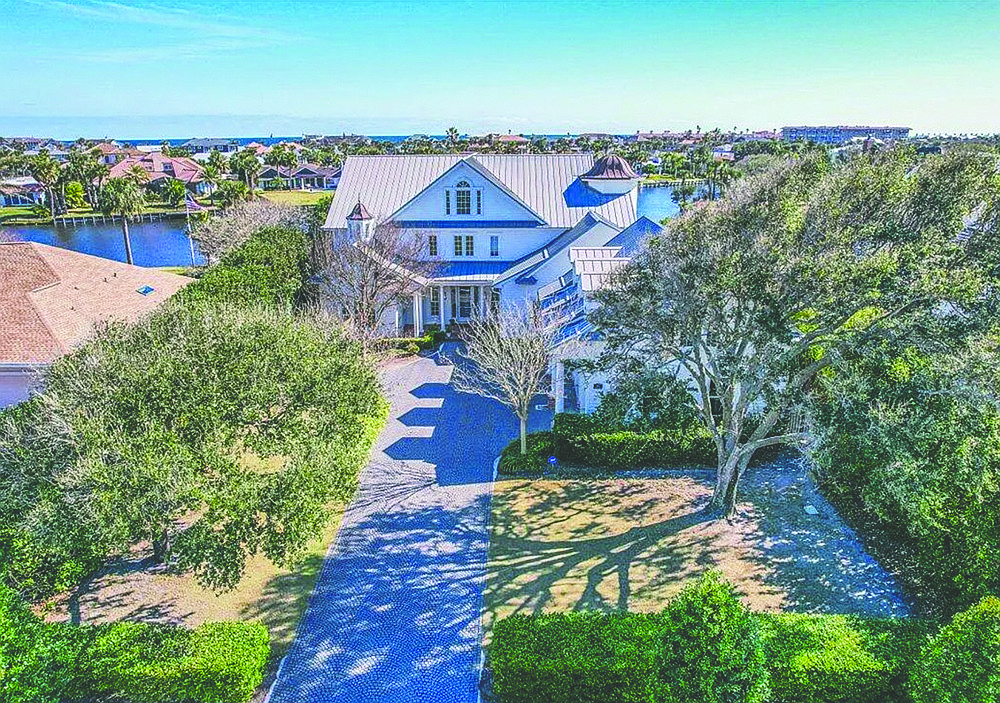 Waterfront home features four bedrooms, five full and one half-bathrooms, elevator, porches, office, patio, generator and three-car garage.