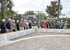 The first wave of participants in the Marie Selby Botanical Gardens groundbreaking scoop some sand.