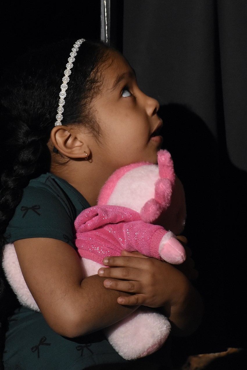 Alani Pinckney, 5, stands beneath the switch in anticipation of the big moment.