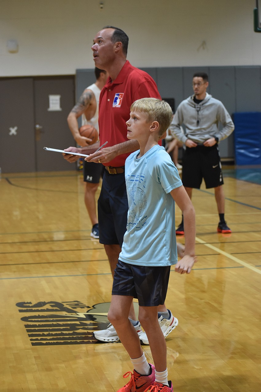 Jeff Bosworth, the Elks chairperson for the event, keeps score of the 10-11 age group as Liam Goutos takes his turn in making 21 out of 30 free throws.