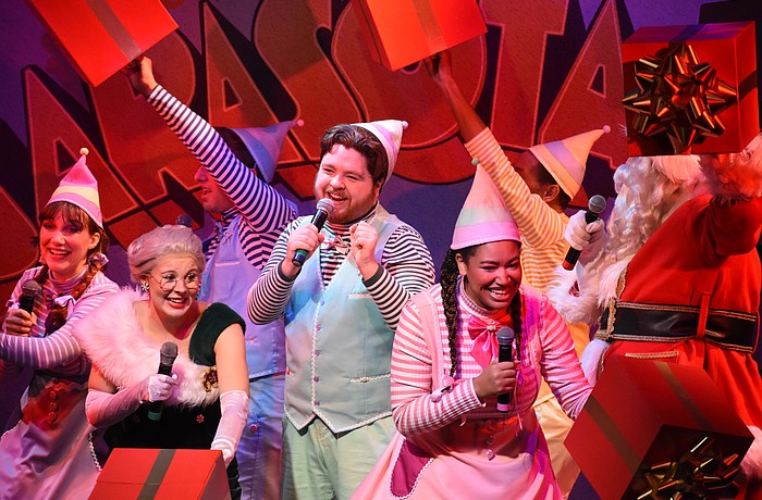 Jolly (Flynn Nolen, center) is surrounded by the other characters including Candy (Christiana Allison), Mrs. Claus (Jillian Hurley), Jangle (Ray Barber), Tinsel (Vanessa Smith), Jingle (Mareece Love) and Santa Claus (Dellan Short).