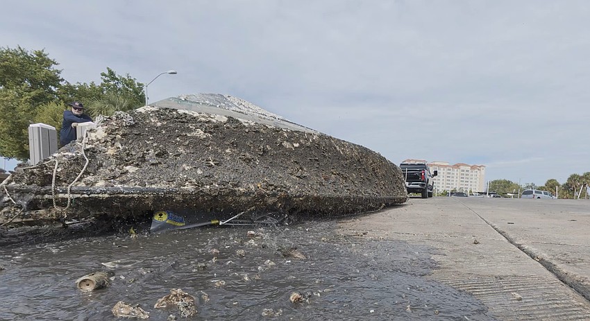 After towing the sunken hull of a boat swamped in Hudson Bayou for more than three years on Monday, Sarasota Police hauled the derelict vessel out of the water at the 10th Street Boat Ramp. After towing the sunken hull of a boat swamped in Hudson Bayou for more than three years on Monday, Sarasota Police hauled the derelict vessel out of the water at the 10th Street Boat Ramp.