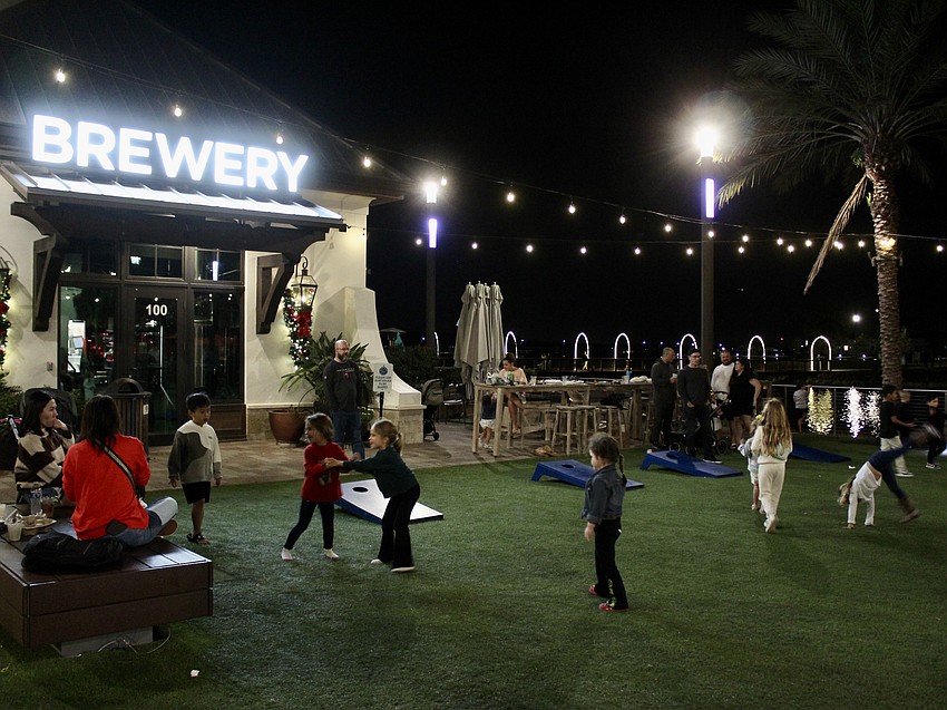 Parents eat and drink, while the kids play on the green between Good Liquid Brewing Company and Duck Donuts.