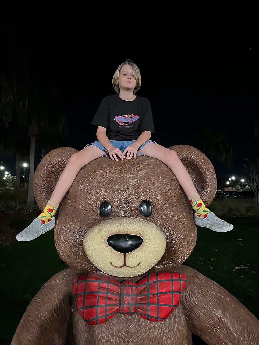 Sarasota's Liam Reilmann strikes a pose with a giant teddy bear.