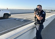 Sarasota Police Officer Michael Pietron uses a radar to check speeds on the Ringling Causeway.