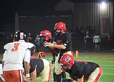 Devin Mignery (center) prepares to take the snap during the FHSAA Class 2A state semifinal between Cardinal Mooney and Cocoa. The senior quarterback was inserted for junior Davin Davidson and helped usher the Cougars into the state championship.