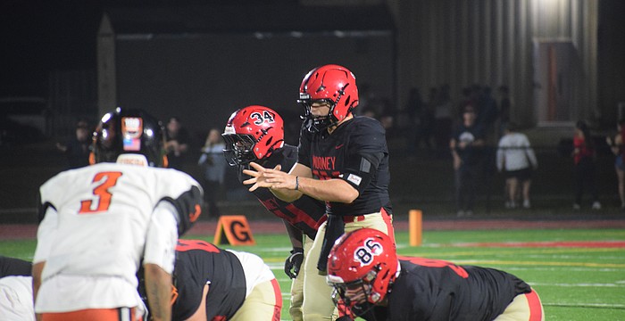 Devin Mignery (center) prepares to take the snap during the FHSAA Class 2A state semifinal between Cardinal Mooney and Cocoa. The senior quarterback was inserted for junior Davin Davidson and helped usher the Cougars into the state championship.