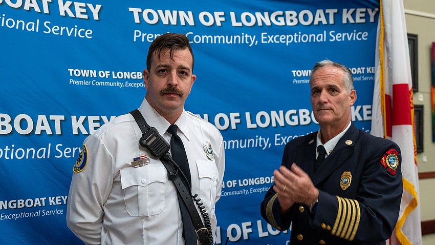 Aaron Maness (left) was awarded the Medal of Honor by Longboat Key Fire Chief Paul Dezzi (right) for his work leading the response to a submerged vehicle.