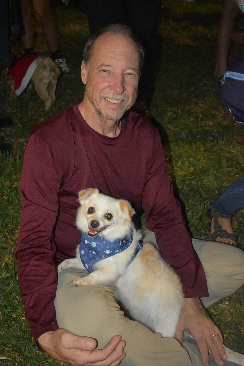 Samuel Munroe sits with Blaze in front of the spot where the tree will be lit.