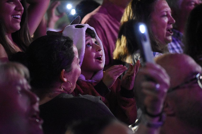 Valerie Flores and Julian Flores, 4, watch as the moment of the lighting arrives.