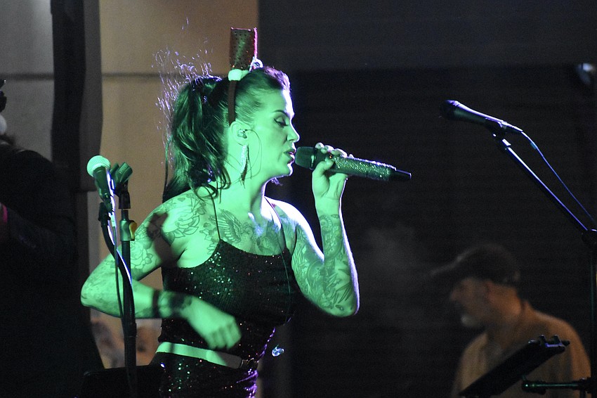 Autumn Tselios of The Rockefellers performs on stage.