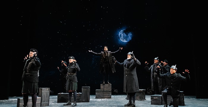 The moon rises as German and English troops gather together in "No Man's Land" to celebrate the birth of Christ in Asolo Rep's "All Is Calm: The Christmas Truce of 1914."