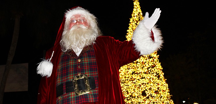 With a sparkle in his eye and a wave of the hand, jolly old St. Nick illuminated the lights on St. Armands Circle's 60-foot Christmas tree at a lighting festival on Dec. 5.