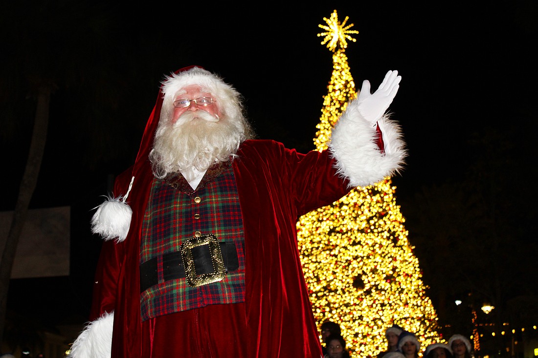 With a sparkle in his eye and a wave of the hand, jolly old St. Nick illuminated the lights on St. Armands Circle's 60-foot Christmas tree at a lighting festival on Dec. 5.