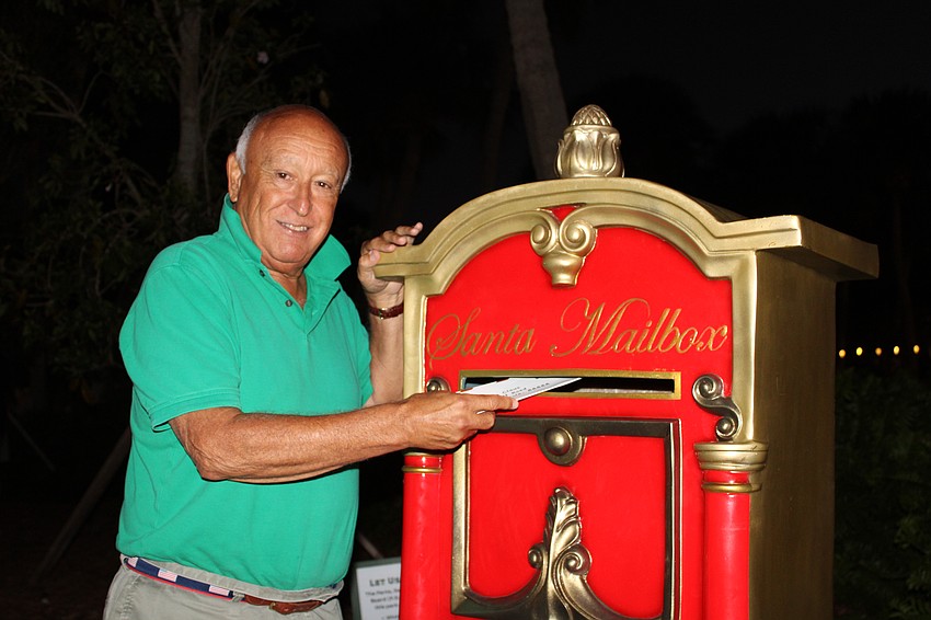 Hugh Fiori posts a letter to the North Pole at Holiday Night on the Circle.