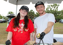 Emily Burns and Jack Coleman of Poppo's Taqueria dish up their popular pork tacos at the Kiwanis Club of Longboat Key's Lawn Party on Dec. 6 at Ken Thompson Park.