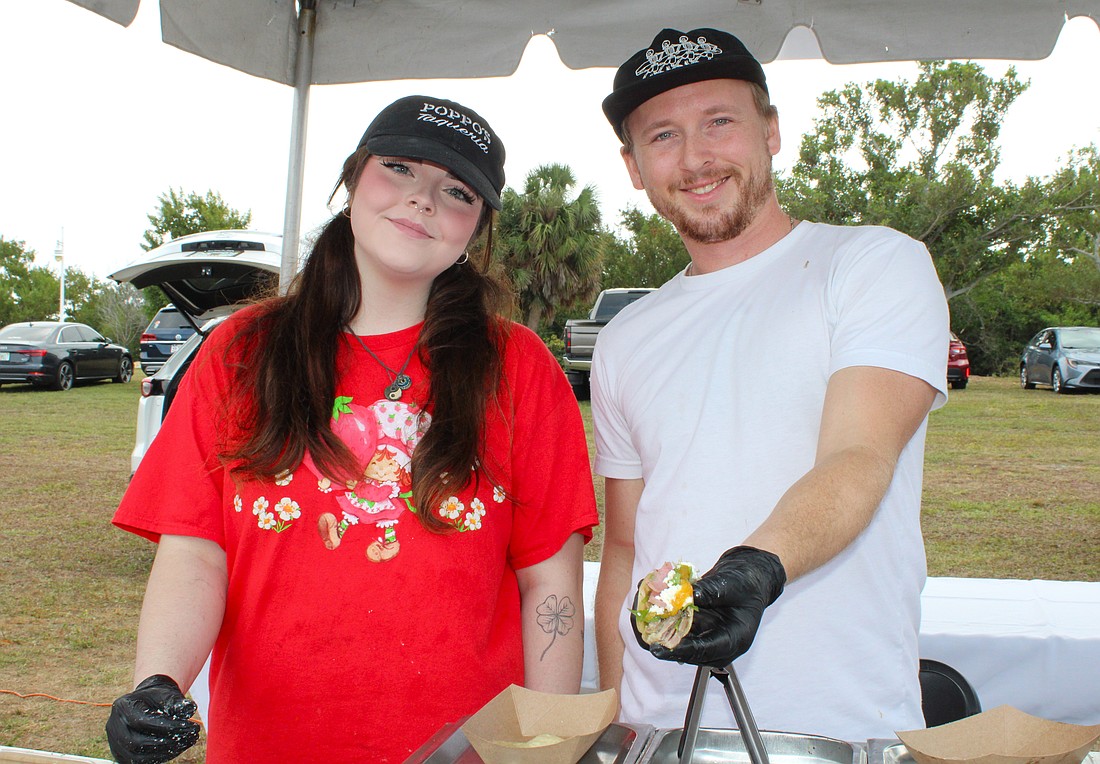 Emily Burns and Jack Coleman of Poppo's Taqueria dish up their popular pork tacos at the Kiwanis Club of Longboat Key's Lawn Party on Dec. 6 at Ken Thompson Park.