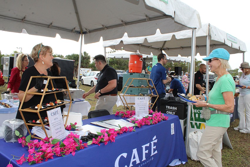 Linda Finnerty of Oysters Rock Hospitality greets Lawn Party guests at the Café on St. Armands booth.