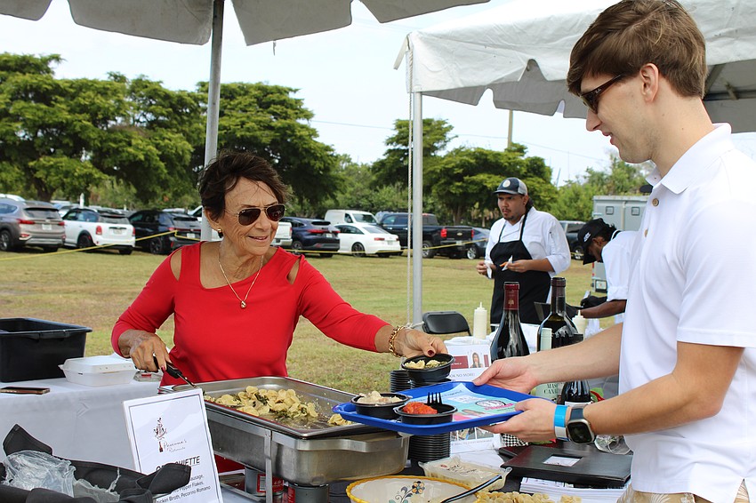 Judy Stanley from Pascone's Ristorante dishes up orecchiette at the Lawn Party.