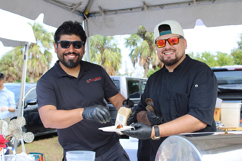 Lazy Lobster team members Sebastian Villaseca and Gabriel Garcia present sticky ribs and smoked Gouda grits at the Lawn Party.
